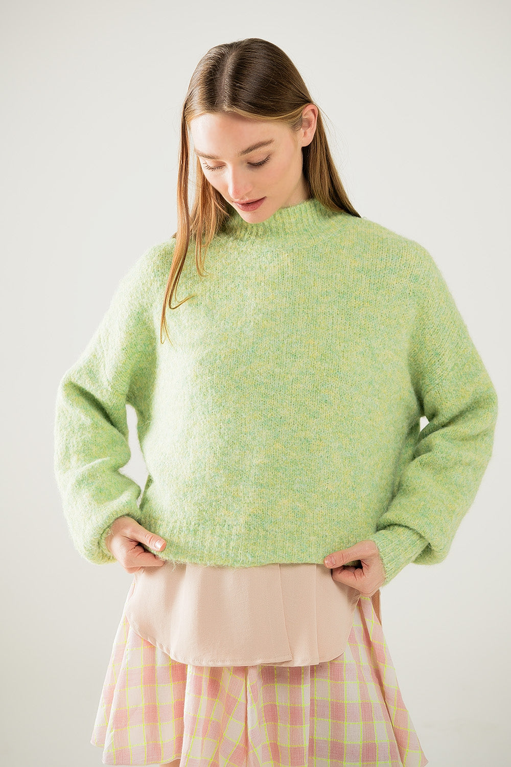 Fluffy light green sweater with high neck and balloon sleeves