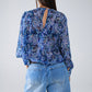 Blusa con estampado abstracto y mangas globo en color azul