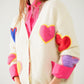 Q2 Beige knitted cardigan with embroidered hearts