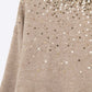Beige soft knit sweater embellished with sequins on the front
