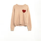 Q2 Beige sweater with red heart detail