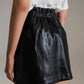 Black faux leather mini skirt with bow on the side