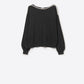 Q2 black fine knit sweater with a boat neck and rhinestone detail