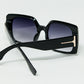 Black square sunglasses with gold detail on the side