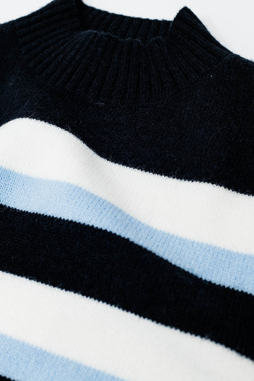 Black sweater with blue and white stripes and a high neck