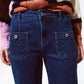 Blue jeans with buttoned pocket details in dark wash