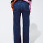 Blue jeans with buttoned pocket details in dark wash