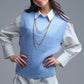 Blue sleeveless sweater with gold buttons on side