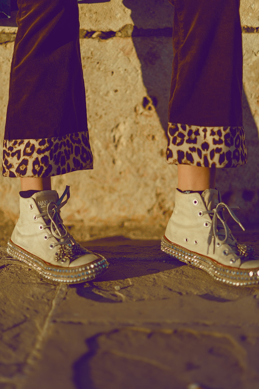 Brown corduroy flare pants with leopard print at the bottom