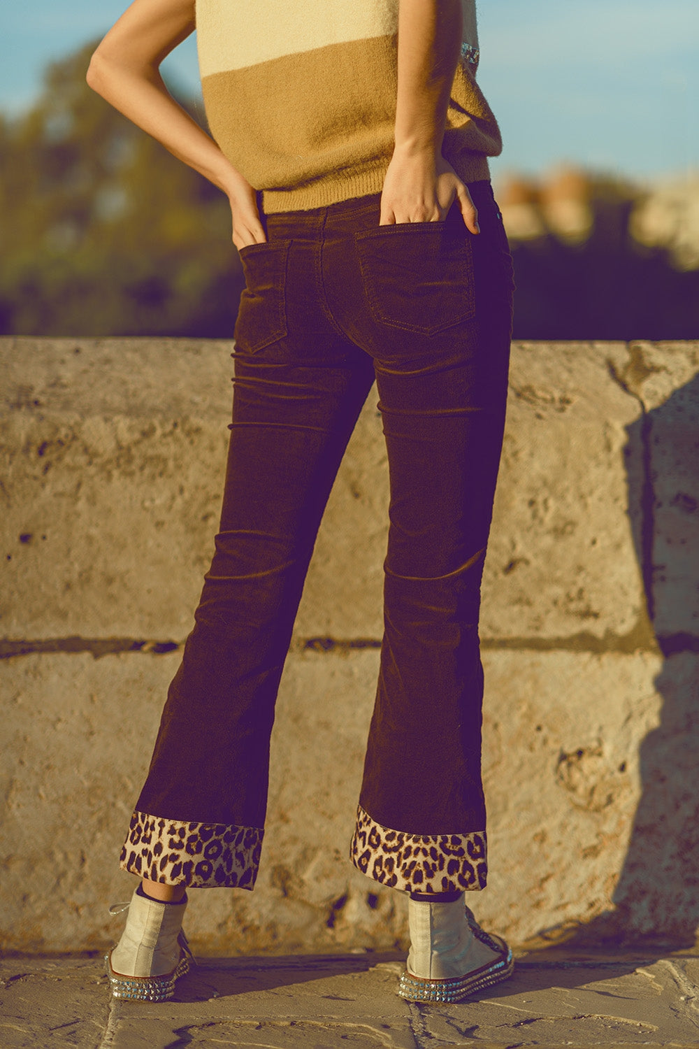 Brown corduroy flare pants with leopard print at the bottom