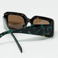 brown square sunglasses with green animal print on the side