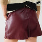 Burgundy faux leather shorts with gathering at the waist with drawstring