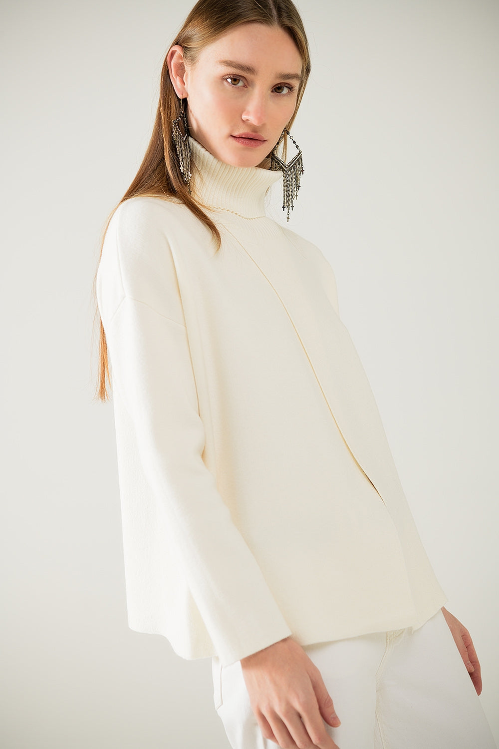 Cream soft knit turtleneck sweater with front slit