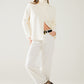 Cream soft knit turtleneck sweater with front slit