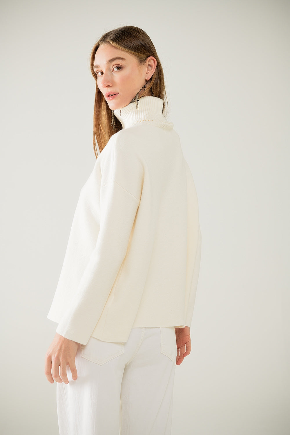 Cream soft knit turtleneck sweater with front slit