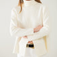 Cream soft knit turtleneck sweater with front slit