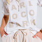 Creme T-shirt With famous Names Logos At The Front