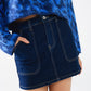 Dark wash denim mini skirt with front pockets