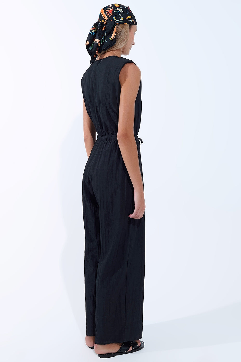 draped black jumpsuit in crinkled fabric
