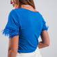 Embellished top with faux feather cuffs in blue