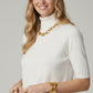 Fine knit sweater in white with a high neck and elbow-length sleeves