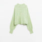 Fluffy light green sweater with high neck and balloon sleeves