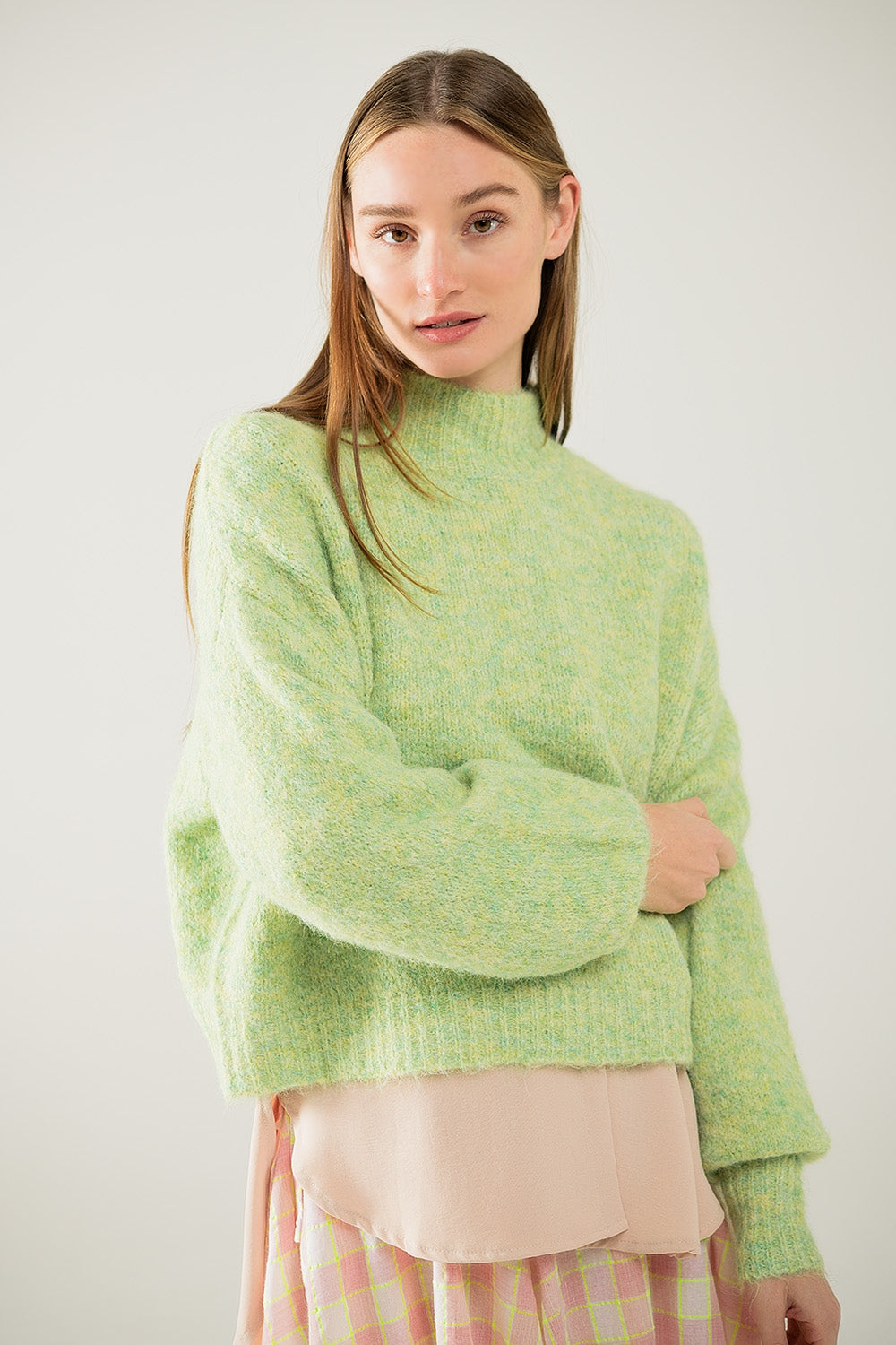 Fluffy light green sweater with high neck and balloon sleeves