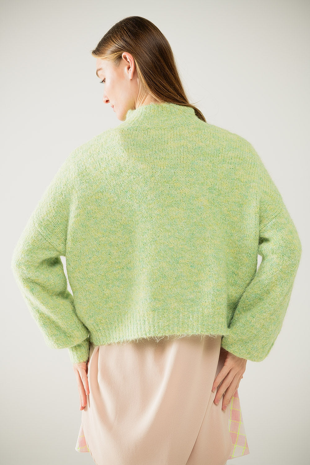 Fluffy light green sweater with high neck and balloon sleeves