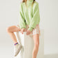 Fluffy light green sweater with high neck and balloon sleeves