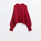 Fluffy red sweater with high neck and balloon sleeves