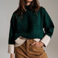 Q2 green jumper with white ribbed cuffs and hem