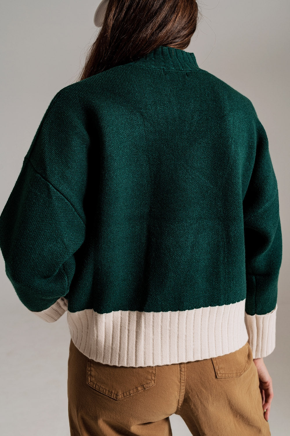 green jumper with white ribbed cuffs and hem