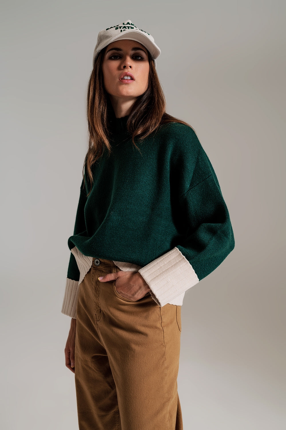 green jumper with white ribbed cuffs and hem