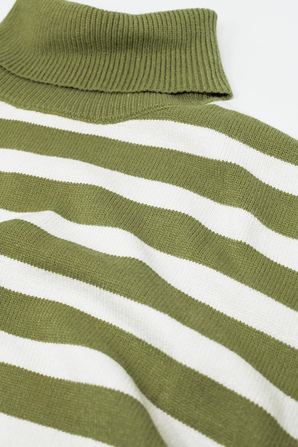 Green oversized trutleneck sweater with white stripes and splits on the side