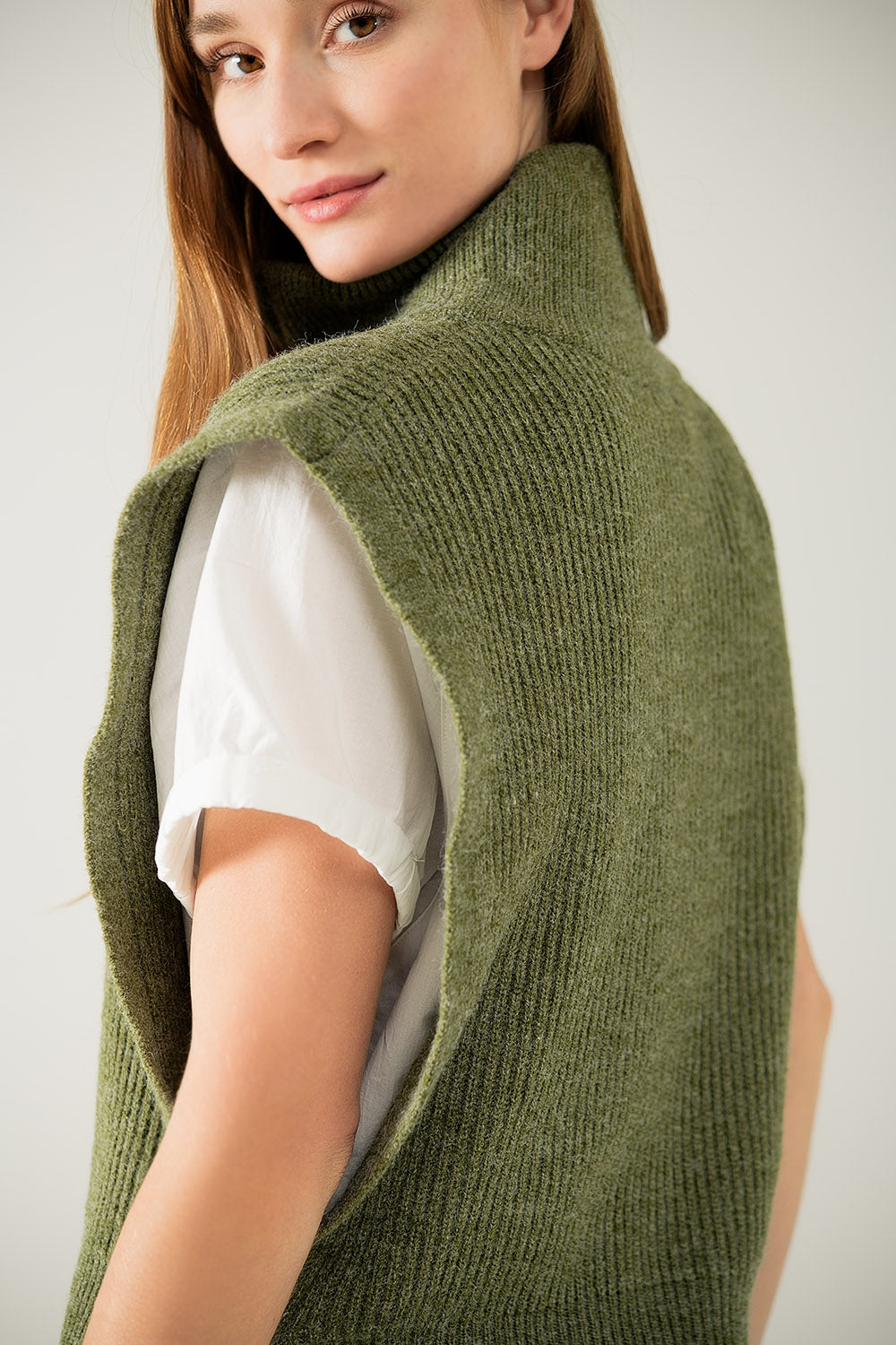 Green sleeveless turtleneck sweater with zipper closure