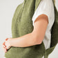 Green sleeveless turtleneck sweater with zipper closure