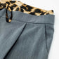 Grey pleated pants with leopard detail at the waist