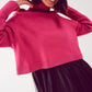 Jersey cropped de cuello alto en fucsia