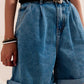 High waisted pleated denim shorts in mid wash