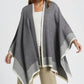 Q2 Knitted poncho in grey with ecru trim