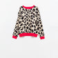 Leopard sweater with red detail on the neck and sleeves