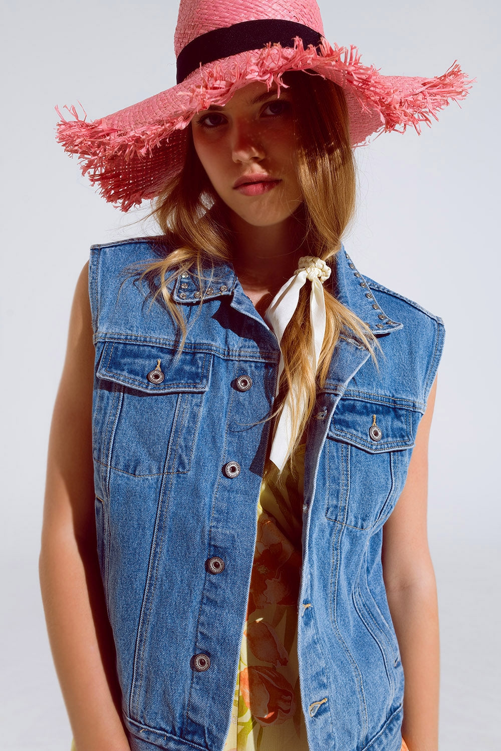 Q2 light wash denim vest with rhinestone detail on the collar