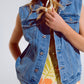 Light wash denim vest with rhinestone detail on the collar