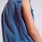 Light wash denim vest with rhinestone detail on the collar