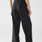 Long black pleated pants with leopard detail at the waist