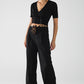 Long black pleated pants with leopard detail at the waist