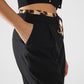 Long black pleated pants with leopard detail at the waist