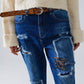 Loose blue jeans with subtle ripped design and patches