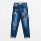 Loose blue jeans with subtle ripped design and patches