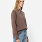 Loose brown sweater with open back detail